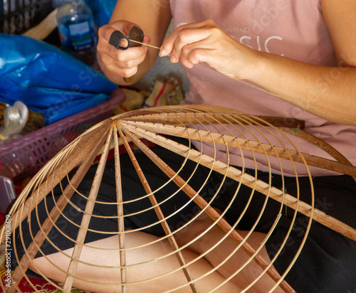 Woman making conical hat