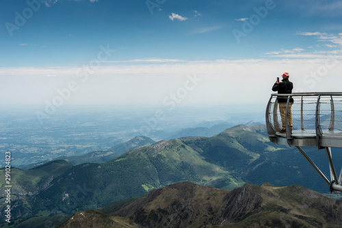 A man contemplates the Pyrenees Mountains from the viewpoint of the astronomical observatory of the Pic du Midi in Bigorre.