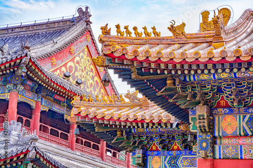 Chinese traditional architecture - colorful ornament and statue dragons on roof of Lama Temple in Beijing, China