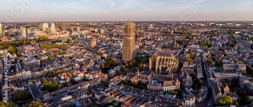 Aerial view of the medieval Dutch city centre of Utrecht with the cathedral in scaffolds towering over the city at early morning sunrise