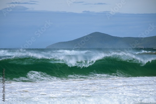Powerful waves with Cape Hawke background 