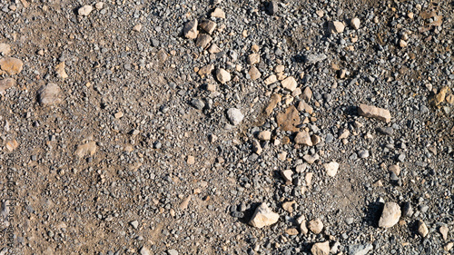 Loose stone aggregate texture featuring large and small stones on a gravel type background.
