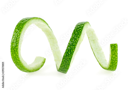 Peel of fresh ripe lime on white background. Lime zest spiral.