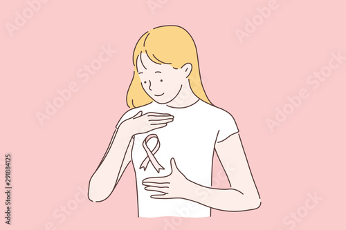 Breast cancer, awareness month concept. Womens day October 15 fight the disease. A young woman or girl smiling looks at a pink ribbon symbol. A lady with cancer doesnt fall in spirit. Volunteering