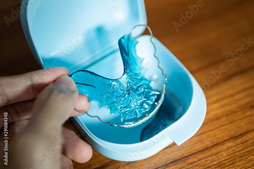 placing retainer for teeth into the plastic box