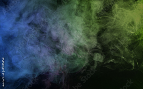 Abstract smoke on a dark background. Movement of color smoke