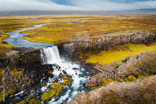 Aerial view autumn landscape in Iceland, rocky canyon with waterfall.