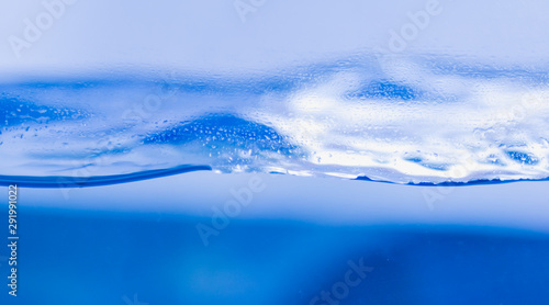 Abstract water wave isolated on blue background.