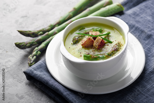 Asparagus soup in white bowl closeup. Food photography