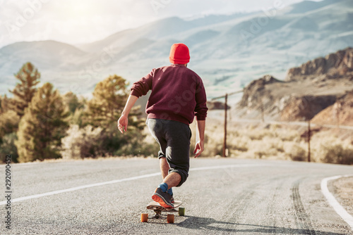 Man skateboarding at mountain road