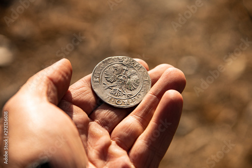 ancient coin in hand