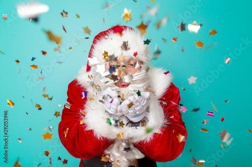 Santa Claus blowing confetti