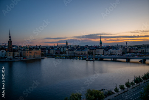 A colorful sunrise over Stockholm with the lights reflecting on the calm water of the sea - 10