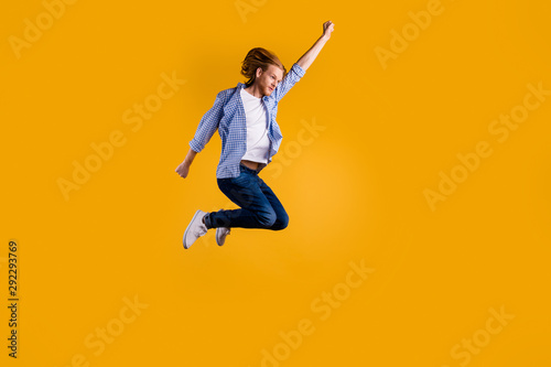 Full size photo of crazy redhead guy jumping high using super power to fly faster and save world wear casual trendy outfit isolated yellow background