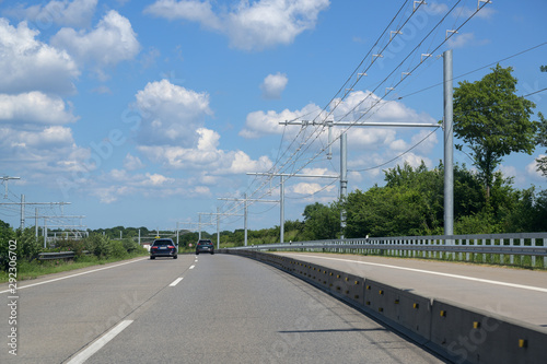 E-Highway with electric overhead contact wire for hybrid trucks, test track in Luebeck, Germany, blue sky with clouds, copy space
