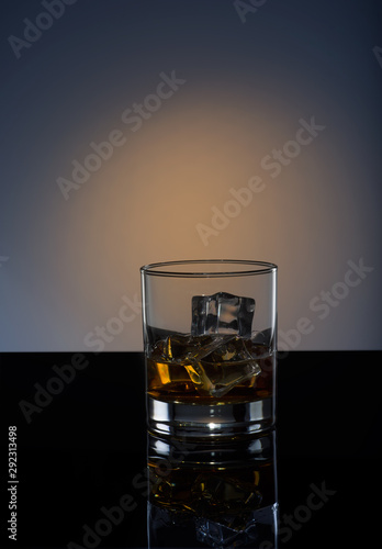 Whiskey with ice on a black background
