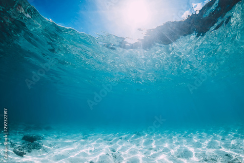 Blue ocean with white sand bottom underwater in Hawaii