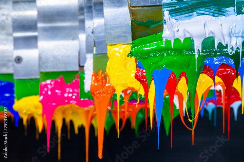 several dripping colors ink on handle printers in tee shirt factory hang on the storage