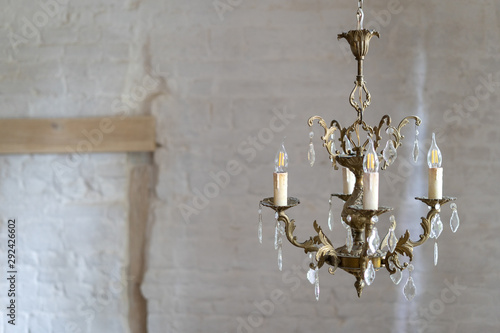 Crystal chandelier lamp against white wall with copy space