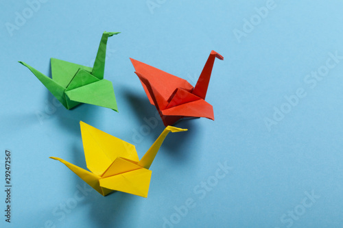 origami paper crane on a blue background