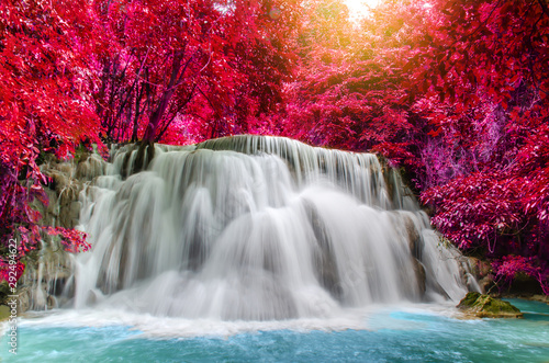 Travel to the beautiful waterfall in deep rainforest in autumn, soft water of the stream in the natural park at Huai Mae Khamin Waterfall in Kanchanaburi, Thailand. 