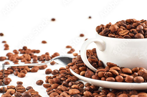 Background of coffee beans and coffee Cup with saucer isolated on white background.
