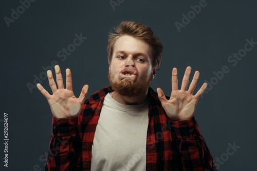 Man's crazy face crushed on transparent glass