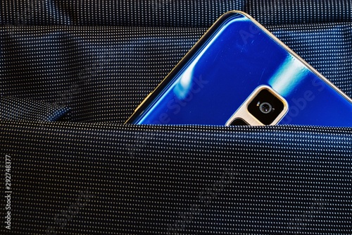 blue mobile phone with a camera in a bag pocket