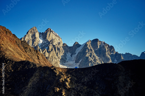 Tent on the background of Ushba. Dawn in the mountains of Svaneti. Georgia. Drone