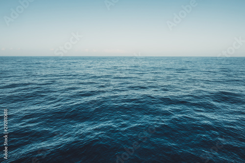 Calm sea surface with waves at sunny day - ocean background
