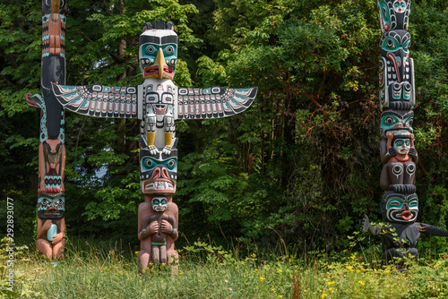 Totem poles located in a clearing of a forest