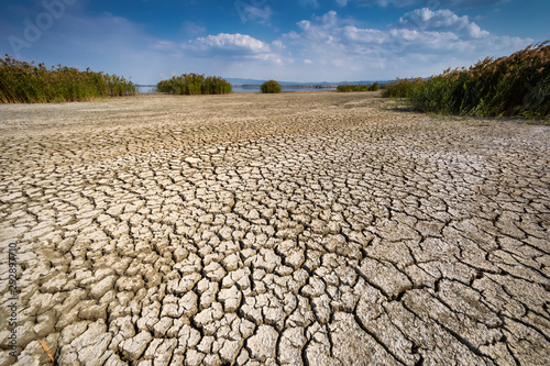 Dry lake bed with natural texture of cracked clay in perspective floor