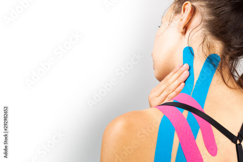Kinesiotaping, kinesiology. Female athlete with kinesiotape, muscle tape on shoulder