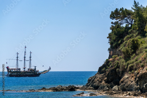 An old three-masted ship swims over a cliff