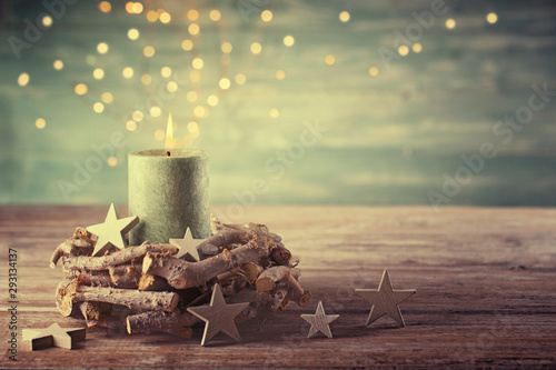 First Advent Sunday - Christmas candle with magic lights - Natural advent decoration - Wreath made of twigs - Rustic simple background 