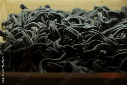 Fresh raw black pasta handmade on the counter closeup