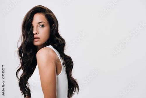 brunette beautiful woman with long healthy and shiny hair looking away isolated on grey