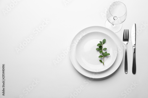 Elegant table setting on white background, top view