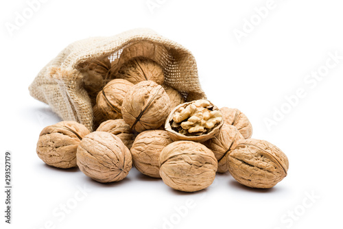 pile of walnuts in juta bag on white background