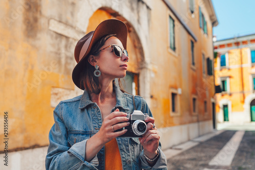 Attractive tourist with a retro camera