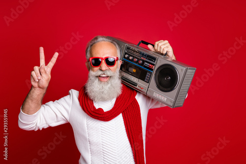 Portrait of his he nice handsome cheerful cheery positive carefree gray-haired man in pullover sweater having fun vintage festive showing v-sign isolated over bright vivid shine red background