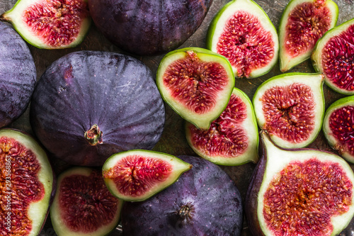 Fresh ripe fig halves. Blue fruit of figs, background