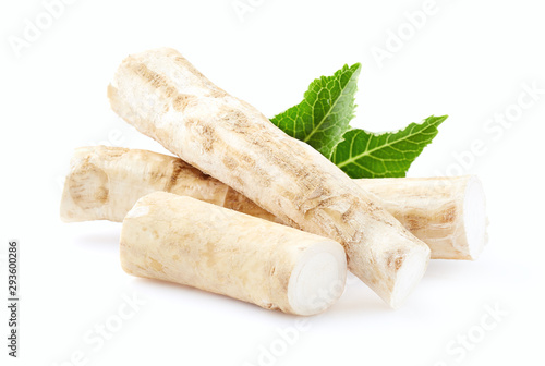 Horseradish root with leaves on white background