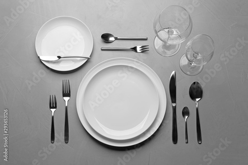 Elegant table setting on grey background, flat lay