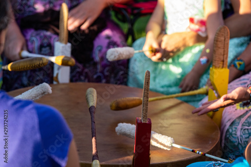 Sacred drums during spiritual singing. A close up view during a traditional singing circle where participants gather round a mother drum and play traditional native music, with copy space.