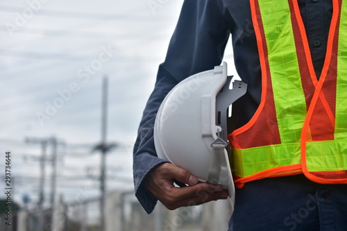 Engineer holding hard hat safety at work place and building development estate heavy architecture contractor, electrician occupation technical foreman, professional use hardhat safety of supervisor