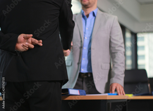 Business man shaking hand with lie sign