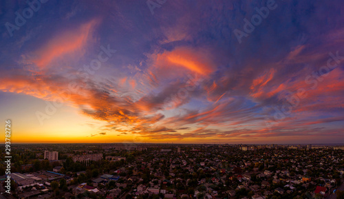 Aerial view amazing sunset over of the suburbs with the city, Giant smoke stack in industrial, far villages and fields