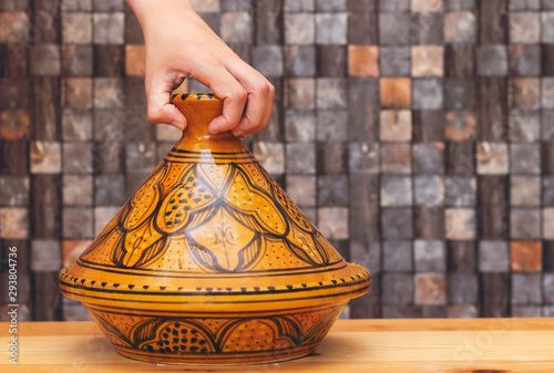 traditional morocco tajine ( means plate in english ) made of clay on wood table