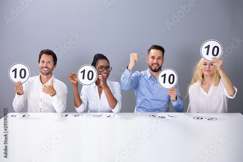 Excited Judges Showing 10 Score Cards For Performance